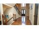 Grand foyer featuring hardwood floors, elegant staircase, and double front doors at 2698 Bonar Hall Path, Duluth, GA 30097