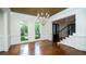 Elegant foyer featuring hardwood floors, staircase with iron railings, and natural light streaming through large windows at 2698 Bonar Hall Path, Duluth, GA 30097