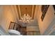 Elegant foyer with a tray ceiling, decorative chandelier, and wrought iron staircase at 2698 Bonar Hall Path, Duluth, GA 30097