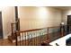 Second floor hallway with wooden railing and views of the main floor below at 2698 Bonar Hall Path, Duluth, GA 30097