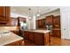 Gourmet kitchen featuring wood cabinets, stainless steel appliances, stone countertops, and a large center island at 2698 Bonar Hall Path, Duluth, GA 30097