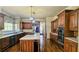 Spacious kitchen with hardwood floors, custom cabinets, a center island with a cooktop, and stainless steel appliances at 2698 Bonar Hall Path, Duluth, GA 30097