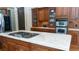Close-up of a kitchen island with a cooktop, marble countertops, and custom wood cabinets at 2698 Bonar Hall Path, Duluth, GA 30097