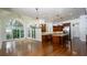 Spacious kitchen with high ceilings, stone countertops, wood cabinets, and abundant natural light through large windows at 2698 Bonar Hall Path, Duluth, GA 30097