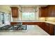 Well-appointed kitchen featuring custom cabinetry, granite countertops, and a stainless steel cooktop at 2698 Bonar Hall Path, Duluth, GA 30097