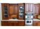 Custom cabinetry featuring glass displays, drawers, and stainless steel ovens, providing ample storage and modern amenities at 2698 Bonar Hall Path, Duluth, GA 30097