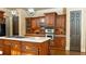 Gourmet kitchen featuring custom wood cabinetry, stainless steel appliances, and a spacious center island with a cooktop at 2698 Bonar Hall Path, Duluth, GA 30097