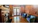 Cozy living room with a fireplace, wood paneling, and comfortable seating, ideal for relaxation and gatherings at 2698 Bonar Hall Path, Duluth, GA 30097