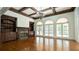 Spacious living room with coffered ceilings, fireplace, hardwood floors, and abundant natural light through large windows at 2698 Bonar Hall Path, Duluth, GA 30097