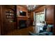 Home living room with hardwood floors, fireplace, built-in shelves, and access to a screened in porch at 2698 Bonar Hall Path, Duluth, GA 30097