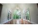 Bright living room with vaulted ceilings and abundant natural light streaming through large windows at 2698 Bonar Hall Path, Duluth, GA 30097
