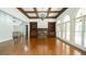 Open-concept living room with coffered ceilings, built-in shelving, a fireplace, and access to the outdoor spaces at 2698 Bonar Hall Path, Duluth, GA 30097