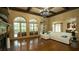 Spacious living room features hardwood floors, a fireplace, large windows, and comfortable seating at 2698 Bonar Hall Path, Duluth, GA 30097