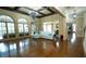 Spacious living room with hardwood floors, large windows, and custom trim at 2698 Bonar Hall Path, Duluth, GA 30097