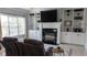 Comfortable living room featuring built-in shelving, a fireplace, and natural light at 2698 Bonar Hall Path, Duluth, GA 30097