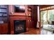 Elegant living room featuring a fireplace, built-in shelves, and easy access to an outdoor screened in porch at 2698 Bonar Hall Path, Duluth, GA 30097
