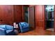 Inviting living room featuring elegant wood paneling and comfortable seating arrangements, with open access to the bathroom at 2698 Bonar Hall Path, Duluth, GA 30097