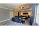 Spacious main bedroom featuring tray ceilings, a ceiling fan, and a cozy seating area at 2698 Bonar Hall Path, Duluth, GA 30097