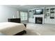 Large bedroom featuring fireplace with built-in shelving, neutral color palette and plush carpeting for a cozy retreat at 2698 Bonar Hall Path, Duluth, GA 30097