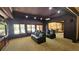 A stylish media room with comfortable theater seating, and large windows offers relaxation and entertainment at 2698 Bonar Hall Path, Duluth, GA 30097