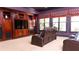Spacious media room with a large built-in entertainment center, theater seating and elegant window treatments at 2698 Bonar Hall Path, Duluth, GA 30097