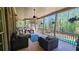 Spacious screened porch with comfortable seating and a view of the outdoor pool and green surroundings at 2698 Bonar Hall Path, Duluth, GA 30097