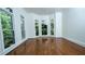 Bright sitting room featuring large windows allowing abundant natural light and hardwood floors at 2698 Bonar Hall Path, Duluth, GA 30097