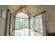 Bright sun room features hardwood floors, high ceilings, and large windows offering panoramic views at 2698 Bonar Hall Path, Duluth, GA 30097