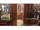 Upscale bar area showcasing wine room entrance with a glass door and an adjacent liquor display cabinet at 2698 Bonar Hall Path, Duluth, GA 30097