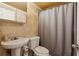 Cozy bathroom featuring stone tile walls, new fixtures, tub and toilet at 300 Peachtree Ne St # 19B, Atlanta, GA 30308