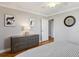 Relaxing bedroom featuring hardwood floors, neutral walls, ceiling fan, closet, and dresser at 300 Peachtree Ne St # 19B, Atlanta, GA 30308