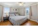 Bright bedroom featuring hardwood floors, neutral walls, ceiling fan, and large windows at 300 Peachtree Ne St # 19B, Atlanta, GA 30308
