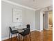 Cozy dining area featuring modern lighting, hardwood floors, neutral walls, and bathroom access at 300 Peachtree Ne St # 19B, Atlanta, GA 30308