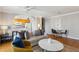Bright living room featuring hardwood floors, neutral walls, ceiling fan, dining area, and kitchen access at 300 Peachtree Ne St # 19B, Atlanta, GA 30308