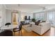 Comfortable living room with hardwood floors, neutral walls, ceiling fan, balcony access, and dining area at 300 Peachtree Ne St # 19B, Atlanta, GA 30308