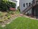 A stone path, flower beds and mature trees surround this lovely home at 1673 Chadwick Ridge Dr, Lawrenceville, GA 30043