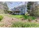 Exterior of home features a backyard with a deck, patio, and mature trees at 1673 Chadwick Ridge Dr, Lawrenceville, GA 30043