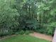 Privacy is assured in this backyard, full of mature trees and flowering bushes at 1673 Chadwick Ridge Dr, Lawrenceville, GA 30043