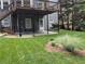 Landscaped backyard features a covered patio, mature trees, and lush green lawn at 1673 Chadwick Ridge Dr, Lawrenceville, GA 30043