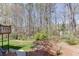 A well maintained lawn, flower beds and mature trees provide privacy in the backyard at 1673 Chadwick Ridge Dr, Lawrenceville, GA 30043