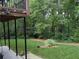 View of the spacious, well-maintained backyard with mature trees and landscaping at 1673 Chadwick Ridge Dr, Lawrenceville, GA 30043