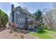 View of backyard with mature trees, landscaping, deck and patio at 1673 Chadwick Ridge Dr, Lawrenceville, GA 30043