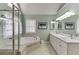 Well-lit bathroom featuring a walk-in shower, tub, double vanity, and decorative starfish curtains at 1673 Chadwick Ridge Dr, Lawrenceville, GA 30043