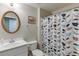 Bathroom with white sink, toilet, and decorative shower curtain at 1673 Chadwick Ridge Dr, Lawrenceville, GA 30043