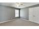 Neutral bedroom with carpet flooring, a double door closet, and a bright window at 1673 Chadwick Ridge Dr, Lawrenceville, GA 30043