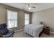 Cozy bedroom features a comfortable bed, a ceiling fan, and natural light at 1673 Chadwick Ridge Dr, Lawrenceville, GA 30043