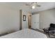 Neutral bedroom with a double door closet, a ceiling fan, and cozy chair at 1673 Chadwick Ridge Dr, Lawrenceville, GA 30043