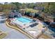 Aerial view of a community pool with ample seating, a pool house, and surrounding greenery at 1673 Chadwick Ridge Dr, Lawrenceville, GA 30043