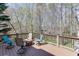 Large deck offers outdoor living with seating area surrounded by mature trees at 1673 Chadwick Ridge Dr, Lawrenceville, GA 30043