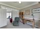 Stylish home office with a comfortable chair, desk, neutral color scheme, and a partial view of living room at 1673 Chadwick Ridge Dr, Lawrenceville, GA 30043
